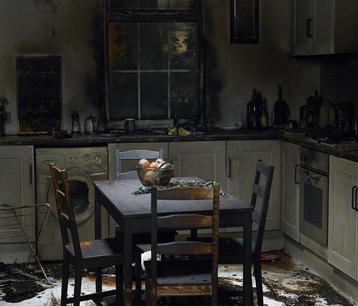 Kitchen covered in soot on the table, cabinets and floor