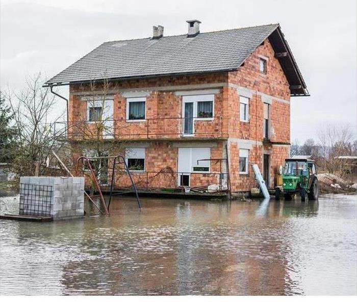 home surrounded by flood water